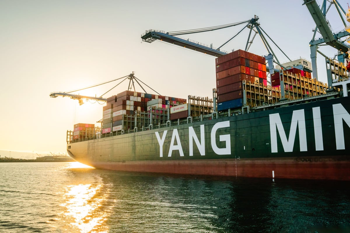 Container ship at a commercial harbour in the evening